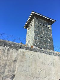 Low angle view of building against clear blue sky