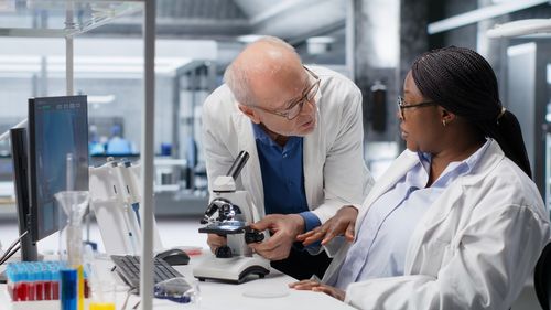 Female doctor examining patient in laboratory