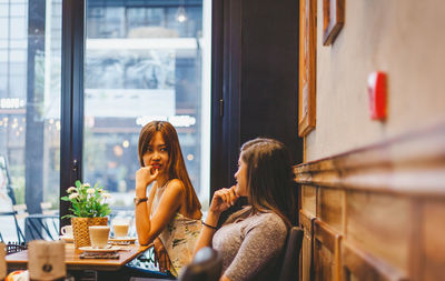 Woman sitting on table at cafe