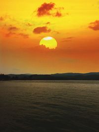 Scenic view of sea against orange sky