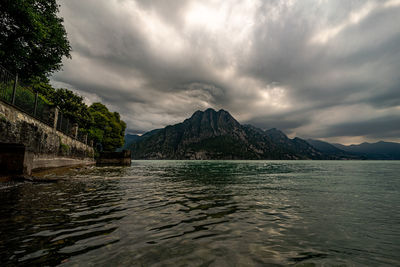 Scenic view of sea and mountains against sky