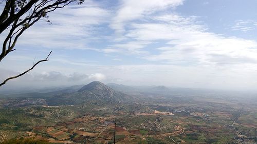 Scenic view of mountains against cloudy sky