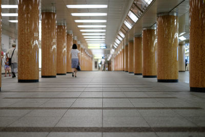 Rear view of man walking in corridor