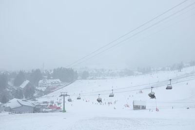 Aerial view of snow covered land against sky