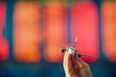 Close-up of hand holding toy airplane