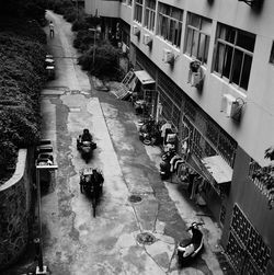 High angle view of people on street amidst buildings in city