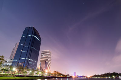 Low angle view of skyscrapers lit up at night