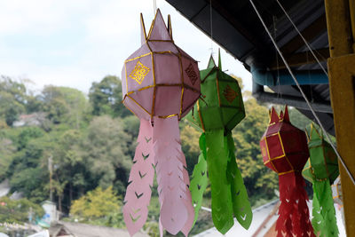 Low angle view of decoration hanging on tree against sky