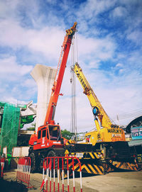 Low angle view of crane against sky