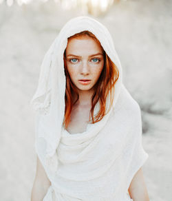 Portrait of beautiful young woman wearing covered scarf 