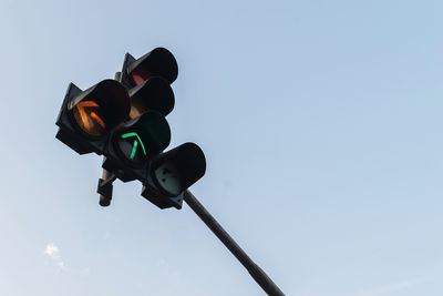 Low angle view of road signal against sky