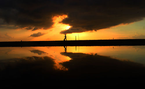 Scenic view of lake against sky during sunset