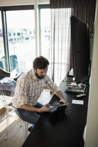 Businessman using digital tablet in hotel room