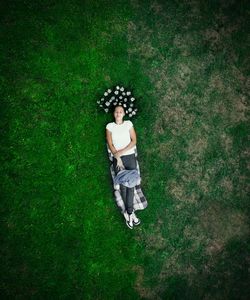 Directly above shot of woman lying on field