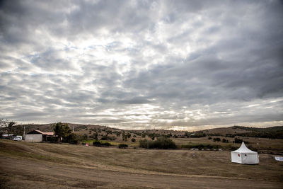 Houses on field against sky