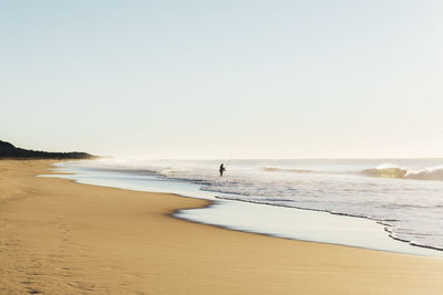 Scenic view of beach against clear sky