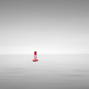 Lighthouse on sea against clear sky