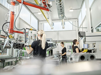 Three women working on machines