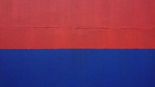 Close-up of blue and red paint wall