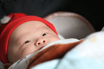 Close-up of baby boy lying on bed