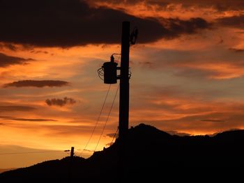 Low angle view of silhouette tower against sky during sunset