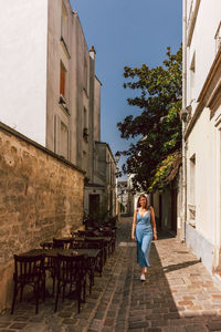 Woman standing by building