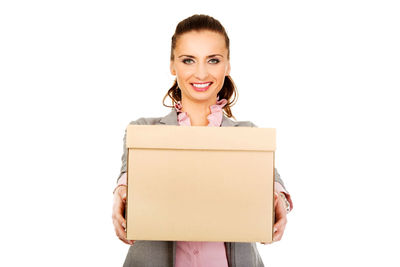 Portrait of a smiling young woman against white background