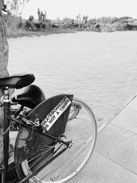 High angle view of bicycle on footpath by lake