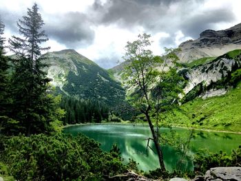 Scenic view of lake and mountains against sky