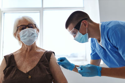 Doctor injecting vaccine to patient