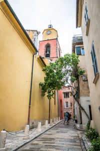 Alley amidst houses and buildings in city