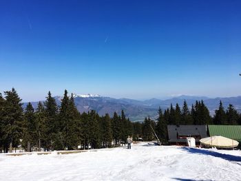 Scenic view of snowcapped mountains against clear blue sky