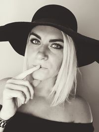 Close-up portrait of young woman wearing hat