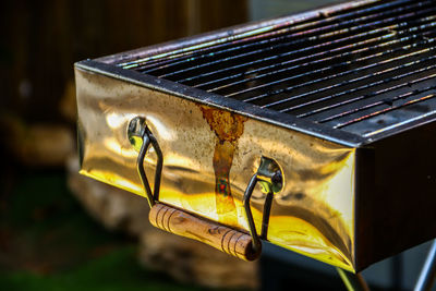 Close-up of yellow metal on wood