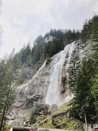 Scenic view of waterfall against sky