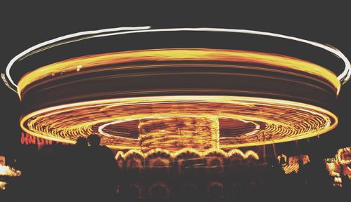 Illuminated ferris wheel at night