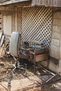 Abandoned chairs against wall in building