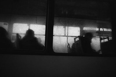 Silhouette people seen through train window