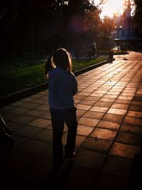 Full length of woman standing on footpath