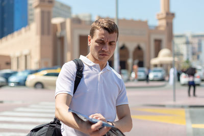 Mid adult man on street in city