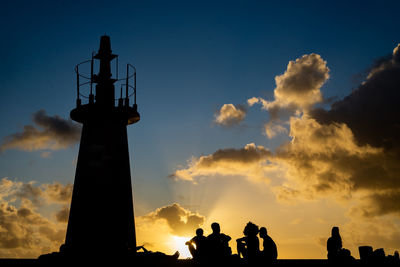 Silhouette of people enjoying the sunset at ponta do humaita.