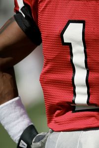 A close up of a red football jersey displaying the number one.