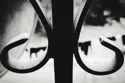 Close-up of metal grate against sky