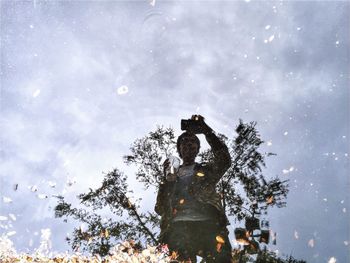 Reflection of trees in puddle