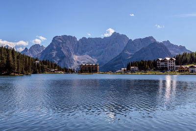 Scenic view of lake by mountains against sky