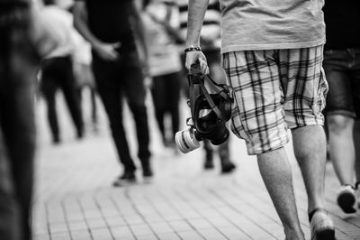 Low section of men walking on footpath