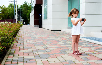 Full length of woman using mobile phone