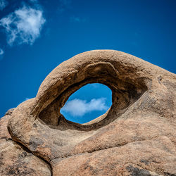 Mobius arch at alabama hills against blue sky