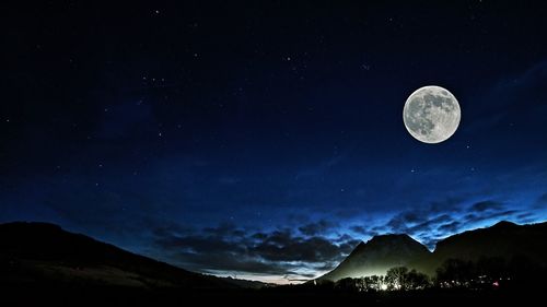 Scenic view of mountains against moon at night