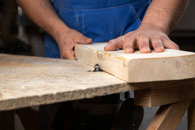 Midsection of man working at workshop